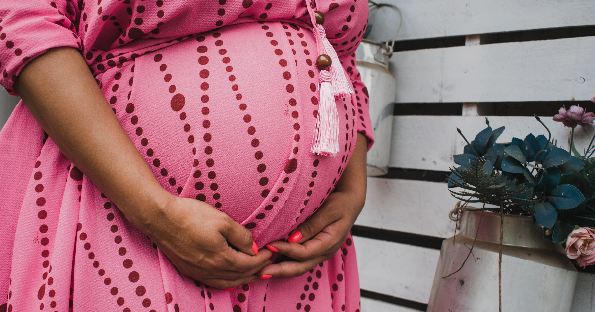 pregnant woman holding belly